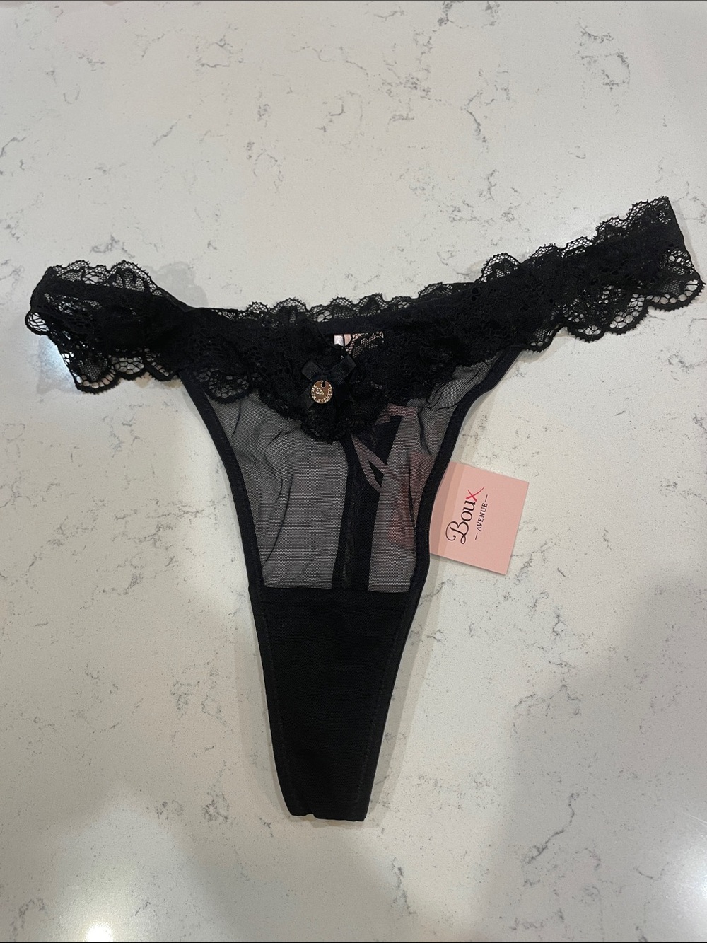 Boux Avenue Black Lace Thong with Sheer Panels and Lace Trim.